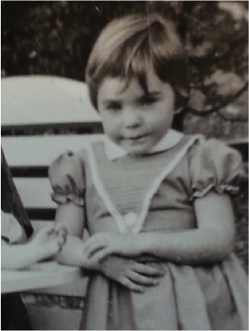 This is a close up of the three or four-year-old from
                Figure 5. The girl leans against the lawn chair, her right elbow resting
                on the arm rest.